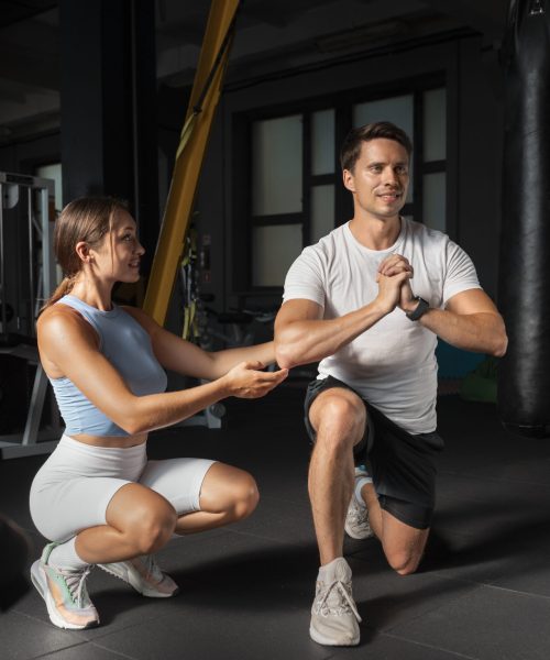 woman-helping-man-gym